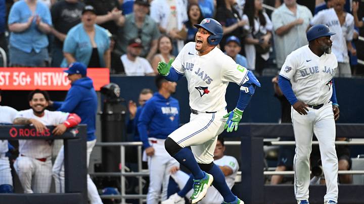 Toronto Blue Jays designated hitter George Springer scores a run.