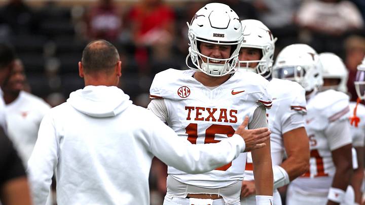 Texas Longhorns quarterback Arch Manning runs the ball with head coach Steve Sarkisian during warm-ups prior to the game against the Mississippi State Bulldogs Texas Longhorns quarterback Arch Manning runs the ball with head coach Steve Sarkisian during warm-ups prior to the game against the Mississippi State Bulldogs