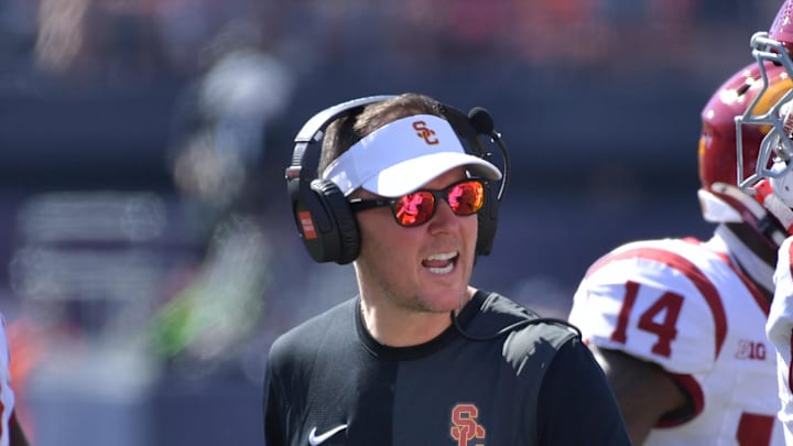 Sep 27, 2025; Champaign, Illinois, USA;  Southern California Trojans head coach Lincoln Riley talks with players during the first half against the Illinois Fighting Illini  at Memorial Stadium. Mandatory Credit: Ron Johnson-Imagn Images