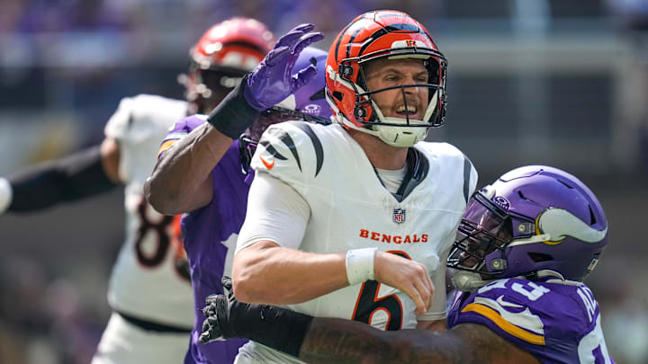 Cincinnati Bengals quarterback Jake Browning (6) is knocked down by Minnesota Vikings defensive tackle Jonathan Allen (93) as he gets a pass off in the second quarter of the NFL Week 3 game between the Minnesota Vikings and the Cincinnati Bengals at U.S. Bank Stadium in Minneapolis on Sunday, Sept. 21, 2025.