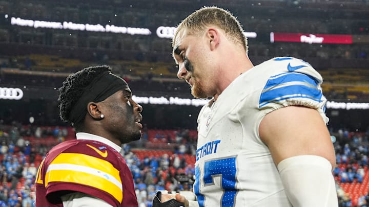 Detroit Lions defensive end Aidan Hutchinson (97) talks Washington Commanders cornerback Mike Sainristil (0) Detroit Lions defensive end Aidan Hutchinson (97) talks Washington Commanders cornerback Mike Sainristil (0)