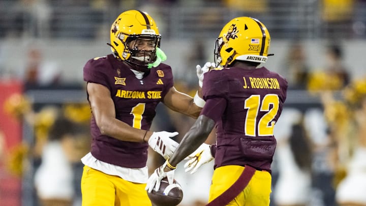 Nov 28, 2025; Tempe, Arizona, USA; Arizona State Sun Devils defensive back Javan Robinson (12) celebrates a fumble recovery with Keith Abney II (1) against the Arizona Wildcats in the first half during the 99th Territorial Cup at Mountain America Stadium. Mandatory Credit: Mark J. Rebilas-Imagn Images