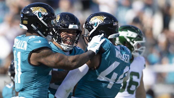 Dec 14, 2025; Jacksonville, Florida, USA; Jacksonville Jaguars defensive end Josh Hines-Allen (41), defensive end Matt Dickerson (93) and defensive end Travon Walker (44) react against the New York Jets at EverBank Stadium. Mandatory Credit: Morgan Tencza-Imagn Images