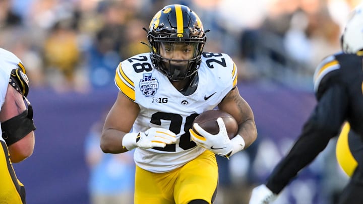 Dec 30, 2024; Nashville, TN, USA;  Iowa Hawkeyes running back Kamari Moulton (28) runs the ball against the Missouri Tigers during the first half at Nissan Stadium. Mandatory Credit: Steve Roberts-Imagn Images