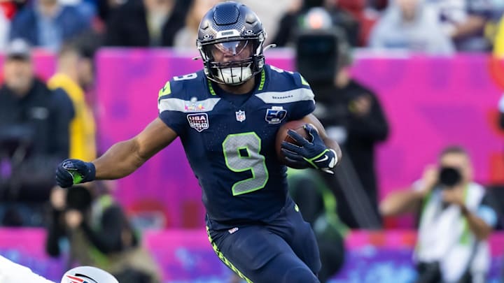 Seattle Seahawks running back Kenneth Walker III runs the ball against New England Patriots defensive end Milton Williams.