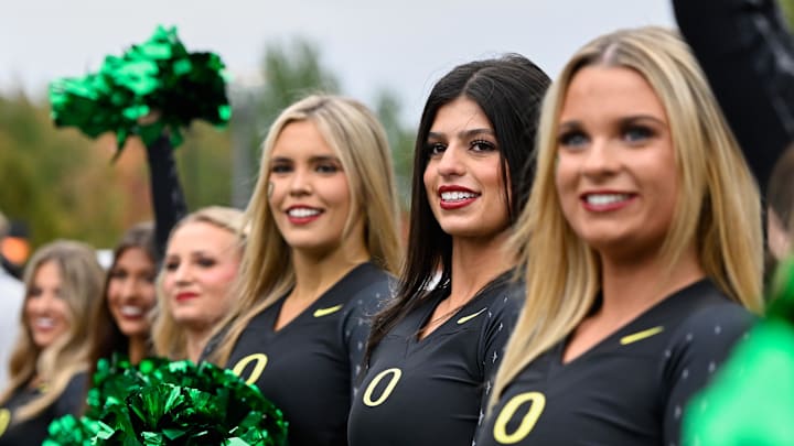 Oct 11, 2025; Eugene, Oregon, USA; Oregon Ducks cheerleaders greet their team as they arrive before the game against the Indiana Hoosiers at Autzen Stadium. Mandatory Credit: Troy Wayrynen-Imagn Images