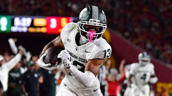 Sep 20, 2025; Los Angeles, California, USA; Michigan State Spartans wide receiver Chrishon McCray (13) scores a touchdown against the against the Southern California Trojans during the first half at the Los Angeles Memorial Coliseum.