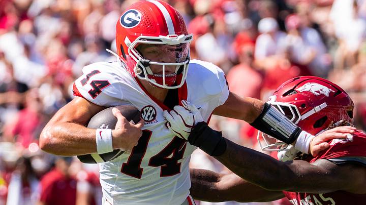 Georgia Bulldogs quarterback Gunner Stockton tackled for a loss by Arkansas Razorbacks linebacker Ja'Quavion Smith.