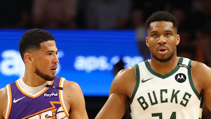 Mar 24, 2025; Phoenix, Arizona, USA; Milwaukee Bucks forward Giannis Antetokounmpo (34) against Phoenix Suns guard Devin Booker (1) at Footprint Center. Mandatory Credit: Mark J. Rebilas-Imagn Images