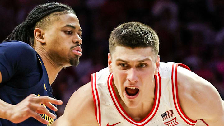 Jan 24, 2026; Tucson, Arizona, USA; Arizona Wildcats forward Ivan Kharchenkov (8) dribbles the ball while the West Virginia Mountaineers attempts to block him during the second half of the game at McKale Memorial Center. Mandatory Credit: Aryanna Frank-Imagn Images