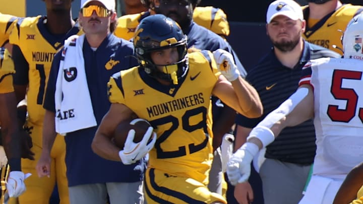 West Virginia University receiver Preston Fox returns a punt against Robert Morris. West Virginia University receiver Preston Fox returns a punt against Robert Morris.