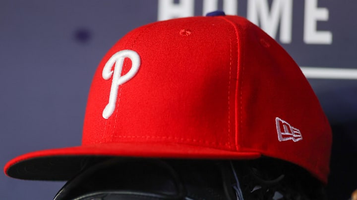 May 26, 2023; Atlanta, Georgia, USA; A detailed view of a Philadelphia Phillies hat and glove on the bench against the Atlanta Braves in the seventh inning at Truist Park. 