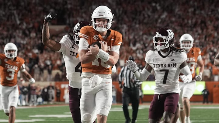 Nov 28, 2025; Austin, Texas, USA; Texas Longhorns quarterback Arch Manning keeps the ball and runs for a touchdown during the second half against the Texas A&M Aggies at Darrell K Royal-Texas Memorial Stadium. Mandatory Credit: Scott Wachter-Imagn Images