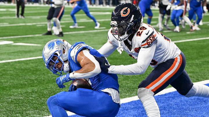 Amon-Ra St. Brown makes a reception for a touchdown in front of  Tyrique Stevenson during last year's first Bears loss to Detroit.