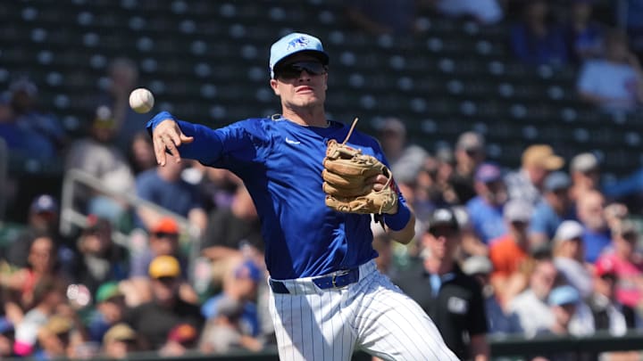 Mar 4, 2025; Mesa, Arizona, USA; Chicago Cubs third baseman Matt Shaw makes the off balance throw for an out against the San Diego Padres in the second inning at Sloan Park. 