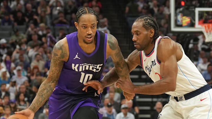 Apr 11, 2025; Sacramento, California, USA; Sacramento Kings forward DeMar DeRozan (10) dribbles against Los Angeles Clippers forward Kawhi Leonard (center right) during the second quarter at Golden 1 Center.