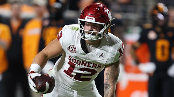 Nov 1, 2025; Knoxville, Tennessee, USA; Oklahoma Sooners tight end Jaren Kanak (12) runs the ball against the Tennessee Volunteers during the second quarter at Neyland Stadium. Mandatory Credit: Randy Sartin-Imagn Images Nov 1, 2025; Knoxville, Tennessee, USA; Oklahoma Sooners tight end Jaren Kanak (12) runs the ball against the Tennessee Volunteers during the second quarter at Neyland Stadium. Mandatory Credit: Randy Sartin-Imagn Images