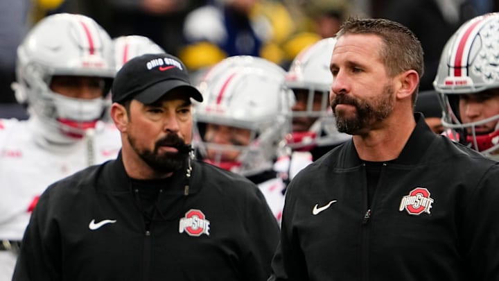 Ohio State Buckeyes offensive coordinator Brian Hartline and head coach Ryan Day leads warm ups during the NCAA football game against the Michigan Wolverines at Michigan Stadium in Ann Arbor, Mich. on Nov. 29, 2025. Ohio State won 27-9.