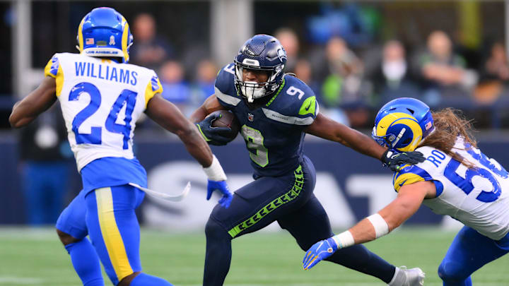Nov 3, 2024; Seattle, Washington, USA; Seattle Seahawks running back Kenneth Walker III (9) stiff arms Los Angeles Rams linebacker Christian Rozeboom (56) during a run play in the second half at Lumen Field. Mandatory Credit: Steven Bisig-Imagn Images