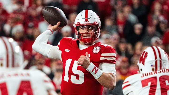 Nov 23, 2024; Lincoln, Nebraska, USA; Nebraska Cornhuskers quarterback Dylan Raiola (15) passes against Wisconsin Badgers defensive lineman Dillan Johnson (76) during the fourth quarter at Memorial Stadium.