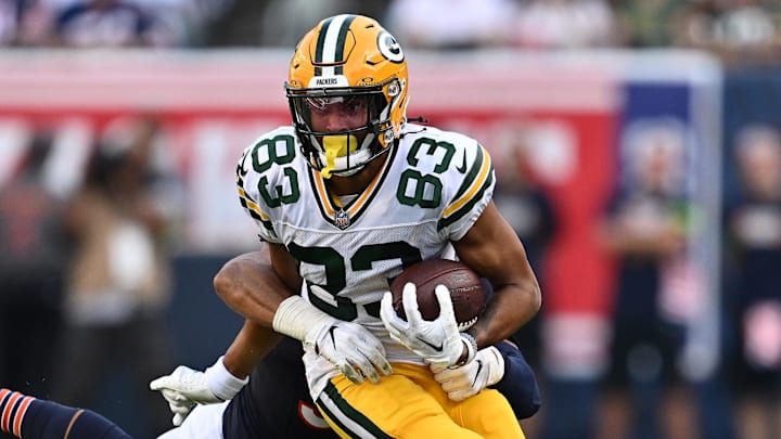 Sep 10, 2023; Chicago, Illinois, USA;  Green Bay Packers wide receiver Samori Toure (83) runs for a gain as Chicago Bears linebacker T.J. Edwards (53) hangs on for the tackle in the second half at Soldier Field. Mandatory Credit: Jamie Sabau-Imagn Images