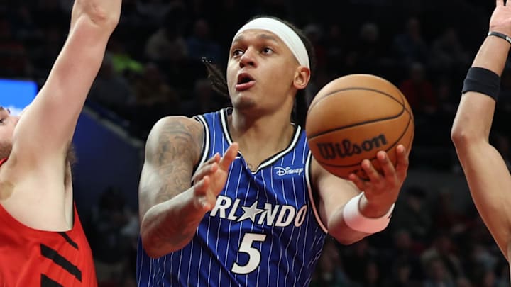 Dec 23, 2025; Portland, Oregon, USA;  Orlando Magic forward Paolo Banchero (5) shoots the ball over Portland Trail Blazers center Donovan Clingan (23) during the second half at Moda Center. Mandatory Credit: Jaime Valdez-Imagn Images