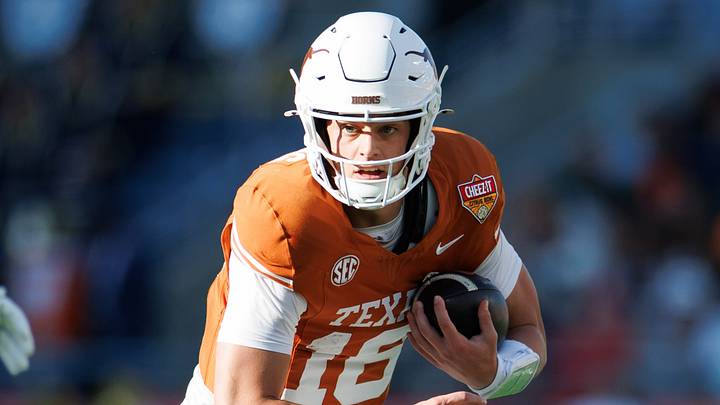 Texas Longhorns quarterback Arch Manning (16) runs with the ball against the Michigan Wolverines during the first half at Camping World Stadium Texas Longhorns quarterback Arch Manning (16) runs with the ball against the Michigan Wolverines during the first half at Camping World Stadium