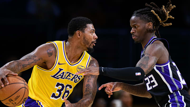 Oct 17, 2025; Los Angeles, California, USA; Los Angeles Lakers guard Marcus Smart (36) looks to drive past Sacramento Kings guard Keon Ellis (23)during the first half at Crypto.com Arena.