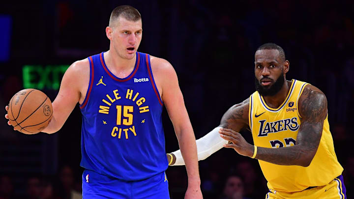 Apr 25, 2024; Los Angeles, California, USA; Denver Nuggets center Nikola Jokic (15) controls the ball against Los Angeles Lakers forward LeBron James (23)  during the second half in game three of the first round for the 2024 NBA playoffs at Crypto.com Arena. Mandatory Credit: Gary A. Vasquez-Imagn Images