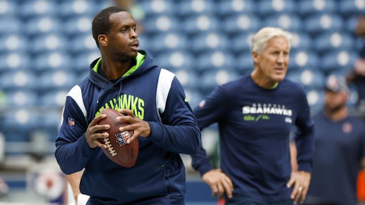 Aug 18, 2022; Seattle, Washington, USA; Seattle Seahawks quarterback Geno Smith (7) participates in early pregame warmups against the Chicago Bears while head coach Pete Carroll (background) watches at Lumen Field.