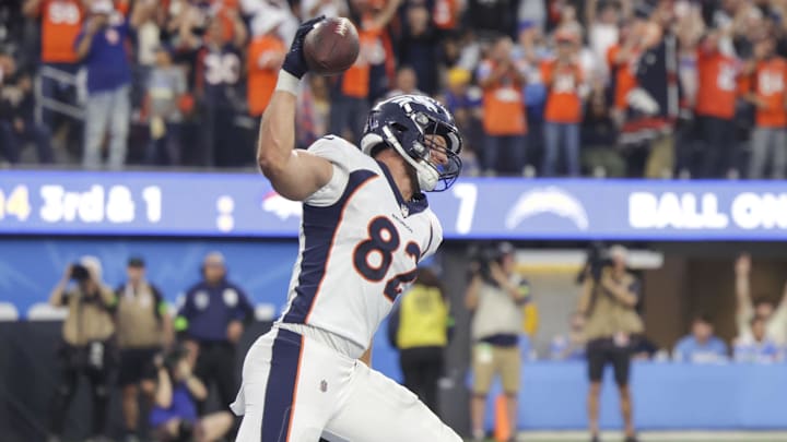 Dec 10, 2023; Inglewood, California, USA; Denver Broncos tight end Adam Trautman (82) celebrates with Denver Broncos quarterback Russell Wilson (3) after scoring a touchdown against the Los Angeles Chargers during the second half at SoFi Stadium. Mandatory Credit: Yannick Peterhans-Imagn Images