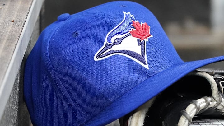 Apr 16, 2025; Toronto, Ontario, CAN; A Toronto Blue Jays hat and glove in the dugout during a game against the Atlanta Braves at Rogers Centre. Apr 16, 2025; Toronto, Ontario, CAN; A Toronto Blue Jays hat and glove in the dugout during a game against the Atlanta Braves at Rogers Centre.