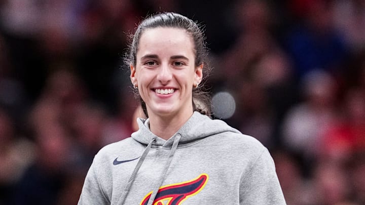 Indiana Fever guard Caitlin Clark smiles during Saturday's preseason game. 