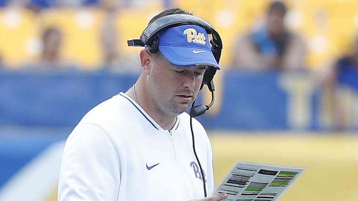 Aug 31, 2024; Pittsburgh, Pennsylvania, USA;  Pittsburgh Panthers offensive coordinator Kade Bell looks at his play chart against the Kent State Golden Flashes during the fourth quarter at Acrisure Stadium. Mandatory Credit: Charles LeClaire-Imagn Images