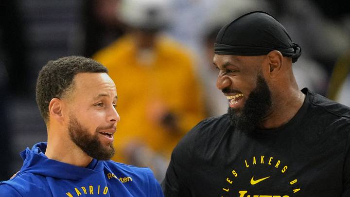 Golden State Warriors guard Stephen Curry (left) and Los Angeles Lakers forward LeBron James (right) talk before the game at Chase Center. 