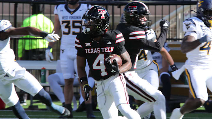 Nov 30, 2024; Lubbock, Texas, USA; Texas Tech Red Raiders wide receiver Jordan Brown (4) runs the ball against the West Virginia Mountaineers in the first half at Jones AT&T Stadium and Cody Campbell Field. Nov 30, 2024; Lubbock, Texas, USA; Texas Tech Red Raiders wide receiver Jordan Brown (4) runs the ball against the West Virginia Mountaineers in the first half at Jones AT&T Stadium and Cody Campbell Field.