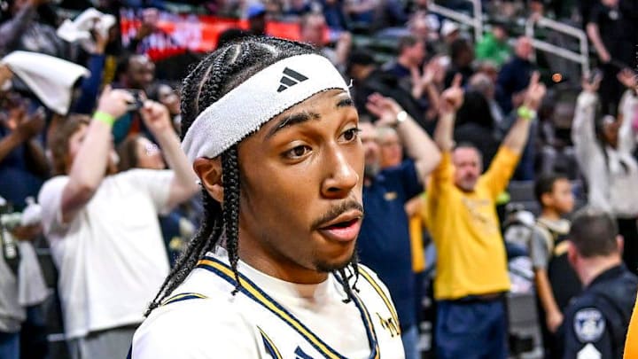 Wayne Memorial's Carlos Medlock Jr., left, shakes hands with Jalahn McClellan after beating Flint Carman-Ainsworth in the Division 1 state semifinal on Friday, March 14, 2025, at the Breslin Center in East Lansing.