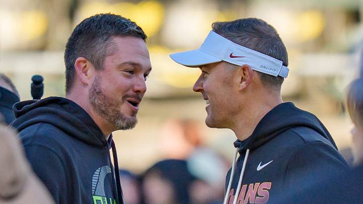 Oregon head coach Dan Lanning, left, and USC head coach Lincoln Riley shake hands before the game as the Oregon Ducks host the USC Trojans on Nov. 22, 2025, at Autzen Stadium in Eugene, Oregon.