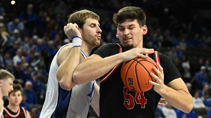 Nov 5, 2025; Omaha, Nebraska, USA; South Dakota Coyotes center Cameron Fens (54) drives against Creighton Bluejays forward Isaac Traudt (41) during the first half at CHI Health Center Omaha. Mandatory Credit: Steven Branscombe-Imagn Images Nov 5, 2025; Omaha, Nebraska, USA; South Dakota Coyotes center Cameron Fens (54) drives against Creighton Bluejays forward Isaac Traudt (41) during the first half at CHI Health Center Omaha. Mandatory Credit: Steven Branscombe-Imagn Images