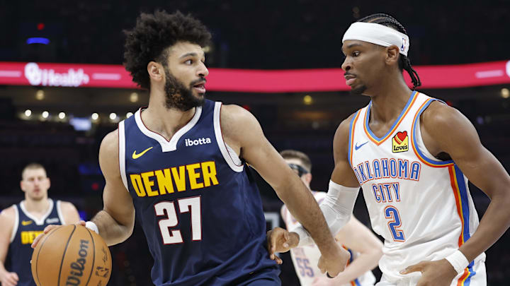 Mar 10, 2025; Oklahoma City, Oklahoma, USA; Denver Nuggets guard Jamal Murray (27) drives against Oklahoma City Thunder guard Shai Gilgeous-Alexander (2) during the second quarter at Paycom Center. Mar 10, 2025; Oklahoma City, Oklahoma, USA; Denver Nuggets guard Jamal Murray (27) drives against Oklahoma City Thunder guard Shai Gilgeous-Alexander (2) during the second quarter at Paycom Center.