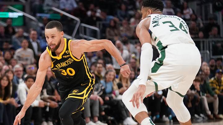 Mar 6, 2024; San Francisco, California, USA; Golden State Warriors guard Stephen Curry (30) dribbles past Milwaukee Bucks forward Giannis Antetokounmpo (34) in the third quarter at the Chase Center. Mandatory Credit: Cary Edmondson-Imagn Images