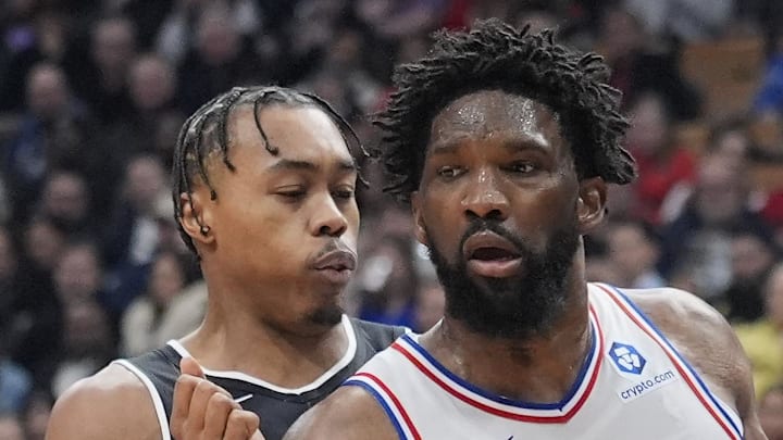 Philadelphia 76ers center Joel Embiid drives to the net against Toronto Raptors guard Scottie Barnes.
