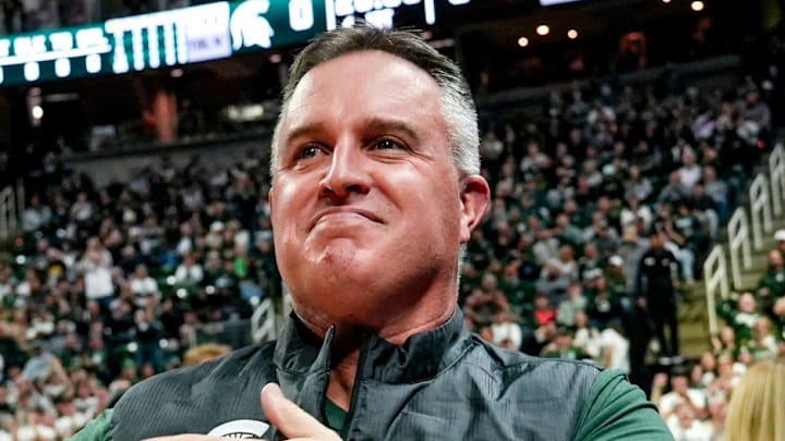 Michigan State's new football coach Pat Fitzgerald pats his heart at the crowd in attendance for the Spartans basketball game against Iowa on Tuesday, Dec. 2, 2025, at the Breslin Center in East Lansing. Michigan State's new football coach Pat Fitzgerald pats his heart at the crowd in attendance for the Spartans basketball game against Iowa on Tuesday, Dec. 2, 2025, at the Breslin Center in East Lansing.