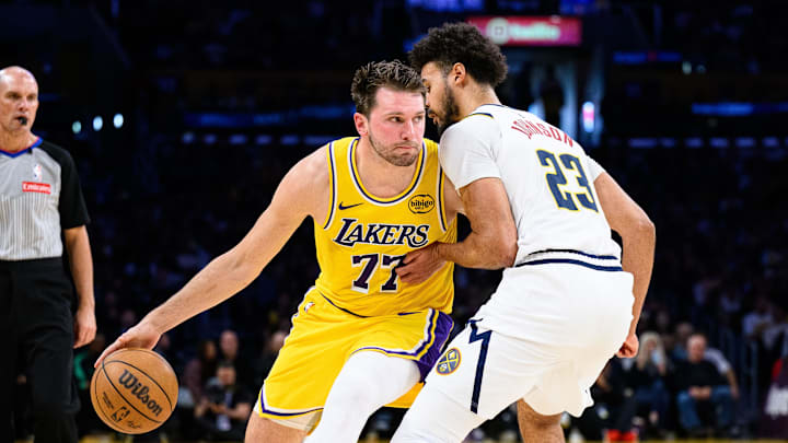 Mar 14, 2026; Los Angeles, California, USA; Los Angeles Lakers guard Luka Doncic (77) drives the ball while under pressure from Denver Nuggets forward Cameron Johnson (23) during the first half at Crypto.com Arena. Mandatory Credit: William Liang-Imagn Images Mar 14, 2026; Los Angeles, California, USA; Los Angeles Lakers guard Luka Doncic (77) drives the ball while under pressure from Denver Nuggets forward Cameron Johnson (23) during the first half at Crypto.com Arena. Mandatory Credit: William Liang-Imagn Images
