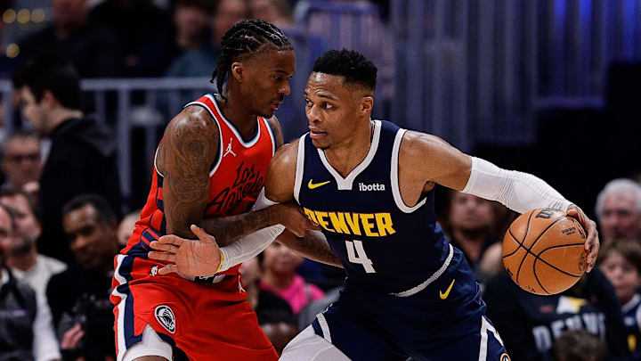 Dec 13, 2024; Denver, Colorado, USA; Denver Nuggets guard Russell Westbrook (4) controls the ball as Los Angeles Clippers guard Bones Hyland (5) guards in the second quarter at Ball Arena. Mandatory Credit: Isaiah J. Downing-Imagn Images