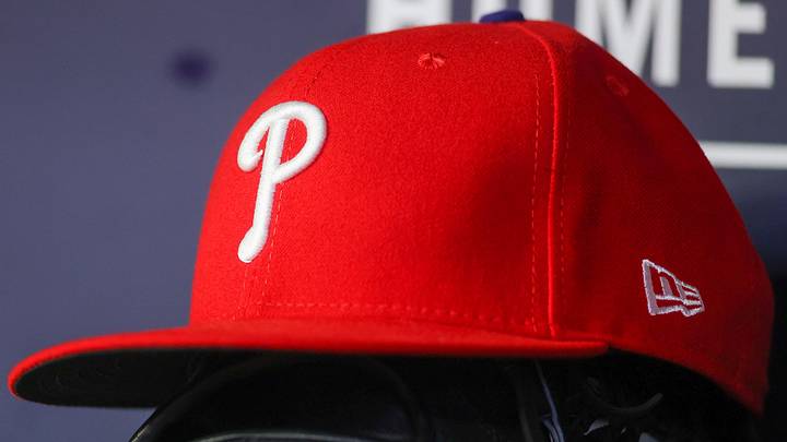 May 26, 2023; Atlanta, Georgia, USA; A detailed view of a Philadelphia Phillies hat and glove on the bench against the Atlanta Braves in the seventh inning at Truist Park.