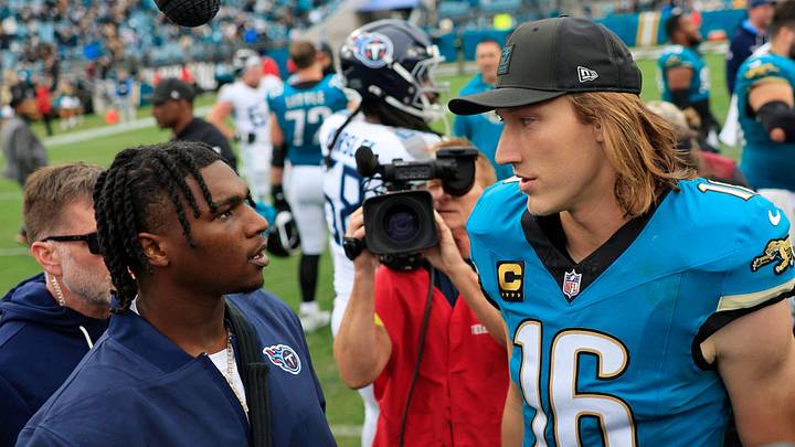 Jacksonville Jaguars quarterback Trevor Lawrence (16) greets Tennessee Titans quarterback Cam Ward (1), left, who was injured in the first quarter, after the game of an NFL football matchup at EverBank Stadium, Sunday, Jan. 4, 2026, in Jacksonville, Fla. The Jaguars defeated the Titans 41-7, capturing the AFC South title. 