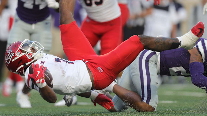 Arizona Wildcats running back Quali Conley (7) lunges for the end zone during the first quarter of the game against Kansas State at Bill Snyder Family Stadium Friday, September 13, 2024. Arizona Wildcats running back Quali Conley (7) lunges for the end zone during the first quarter of the game against Kansas State at Bill Snyder Family Stadium Friday, September 13, 2024.