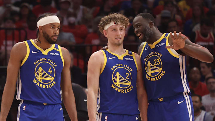 Apr 30, 2025; Houston, Texas, USA; Golden State Warriors forward Draymond Green (23) talks to guard Brandin Podziemski (2) and guard Moses Moody (4) before playing against the Houston Rockets in the second quarter during game five of first round for the 2025 NBA Playoffs at Toyota Center. Mandatory Credit: Thomas Shea-Imagn Images