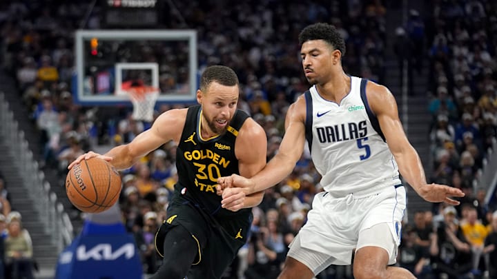 Nov 12, 2024; San Francisco, California, USA; Golden State Warriors guard Stephen Curry (30) dribbles past Dallas Mavericks guard Quentin Grimes (5) in the third quarter at the Chase Center. Mandatory Credit: Cary Edmondson-Imagn Images
